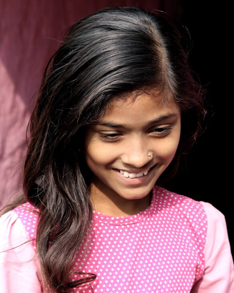 Smiling girl in pink dress